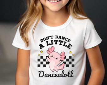 May include: White t-shirt with a pink axolotl dancing on a checkered background. The text reads "Don't Dance A Little Dancealotl".