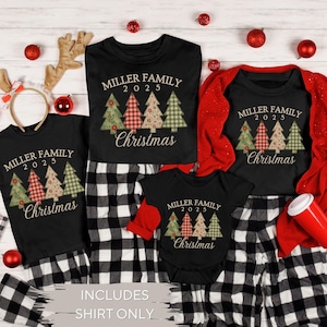 May include: Black family Christmas shirts with matching black and white plaid pajama pants. Each shirt features the text "MILLER FAMILY 2025 Christmas" and a Christmas tree design. The image includes a baby onesie and adult shirts.