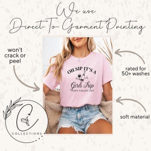 May include: Pink t-shirt with the text "Oh Sip It's a Girls Trip Napa Valley 2025" and a graphic of a wine bottle and glasses.