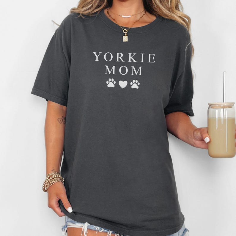 May include: A dark gray t-shirt with the text "Yorkie Mom" and two paw prints and a heart in white.