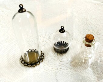 May include: Three glass jars with metal lids and decorative trim. The jars are clear and have a vintage look.