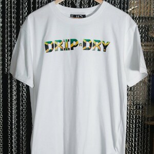 May include: White t-shirt with the words "DRIP-DRY" printed in green, yellow, and black, resembling the Jamaican flag.