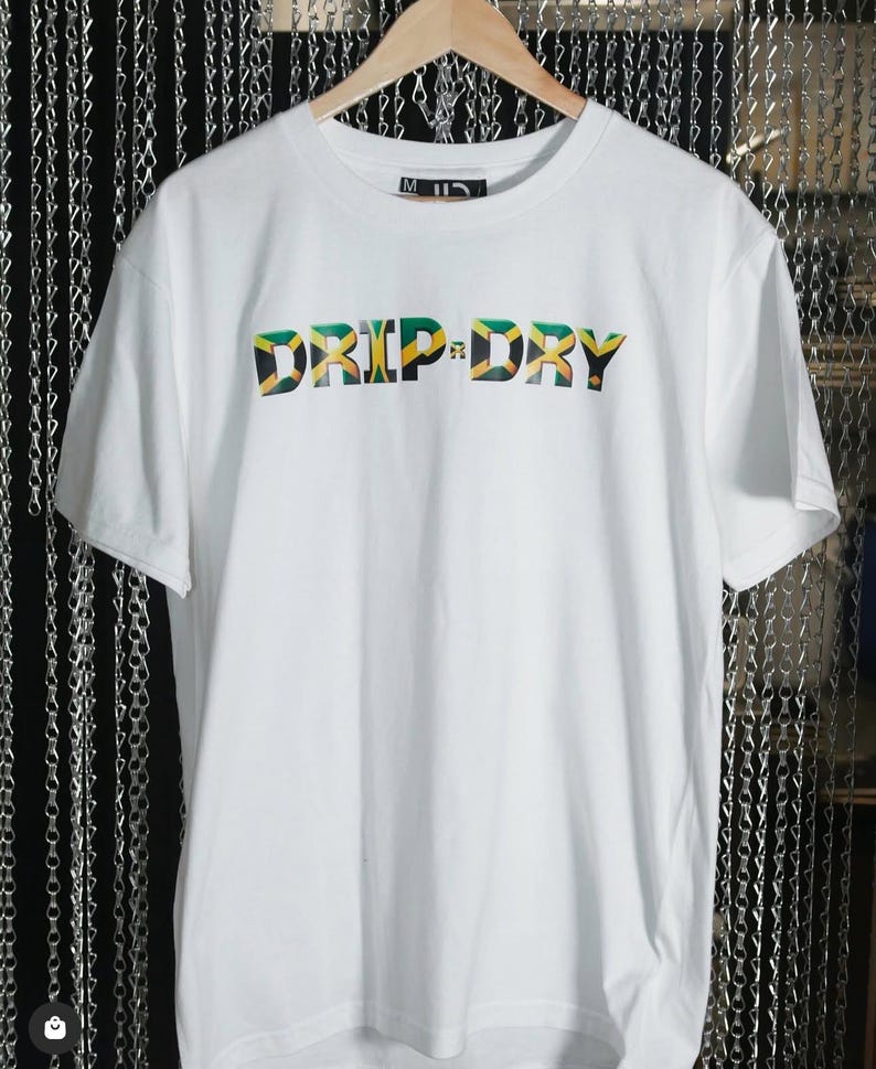 May include: White t-shirt with the words "DRIP-DRY" printed in green, yellow, and black, resembling the Jamaican flag.