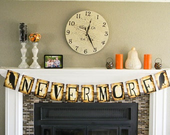 May include: A Halloween banner with the words "Nevermore" in black letters on a brown background. The banner is strung across a fireplace mantel with black ravens on each end.