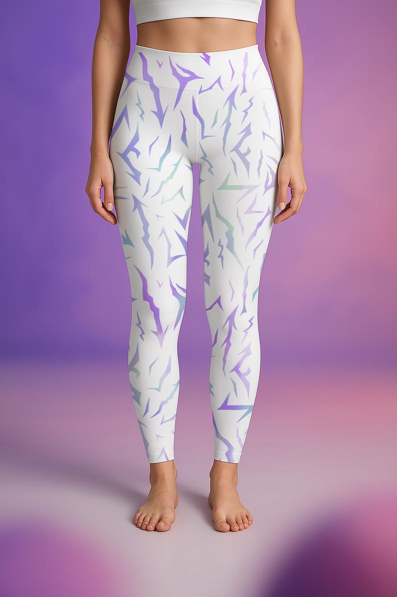 May include: White leggings featuring a repeating pattern of jagged, lightning bolt-like shapes in purple and teal. The leggings are high-waisted and form-fitting, suitable for athletic activities or casual wear.