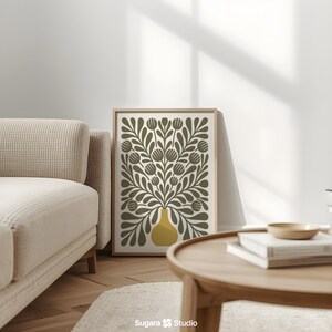 May include: A framed art print featuring a stylized floral design. The artwork showcases a yellow vase filled with olive-green leaves and flower-like shapes against a cream background. The print is displayed in a light-colored wooden frame, adding a touch of natural warmth to the decor.