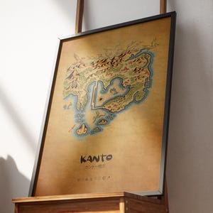May include: Framed print of the Kanto region map, showcasing a detailed illustrated landscape with mountains, water, and landmarks. The print has a vintage aesthetic with a brown background and the word "KANTO" in bold text.