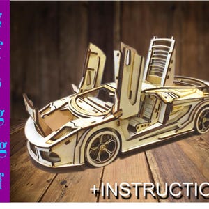 May include: A wooden model kit of a sports car with the doors open. The model is made of laser-cut wood and comes with instructions. +INSTRUCTION
