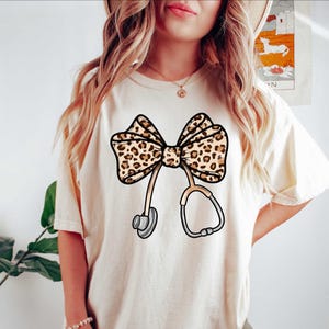 Coquette Nurse Shirt, Leopard Print Stethoscope Bow, T-Shirt or Sweatshirt, Gift for Nurse, Nurse Graduation, Healthcare Shirt, Nurse Tee