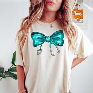Coquette Nurse Stethoscope Bow Shirt, Gift for Nurse, Bow Oversized Shirt, Nurse Appreciation, Christmas Gift for Nurse, Cute Nurse Bow Tee