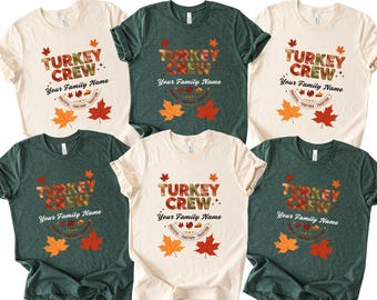 May include: A collection of six short-sleeved t-shirts in various colors, including cream and dark green. Each shirt features the text "TURKEY CREW" in a fall-themed font, with space for a family name, and autumn leaf graphics.