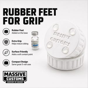 May include: White, cylindrical case with the text "MASSIVE CUSTOMS" and "RUBBER FEET FOR GRIP". The case has rubber feet and is designed for extra grip. A small vial is also visible.