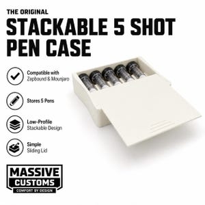 May include: A cream-colored stackable pen case with a sliding lid, holding five pens. The case has the text "STACKABLE 5 SHOT PEN CASE" and "MASSIVE CUSTOMS". The design is low-profile and stackable.