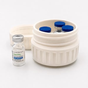 May include: A white container with a lid, holding several small vials with blue caps. One vial is outside the container, labeled "NeuYeu" with text indicating dosage and use. The image is set against a white background.
