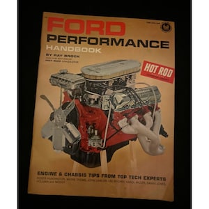 May include: A vintage "Ford Performance Handbook" book cover. The cover features a red and silver engine with the text "FORD PERFORMANCE HANDBOOK" in red. The book is from Hot Rod Magazine and includes engine and chassis tips.