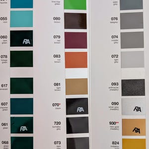 May include: Color swatches arranged in vertical strips, showcasing a variety of hues. The palette includes shades of blue, green, brown, and gray, with metallic and matte finishes. Each color is labeled with a number and a descriptive name.