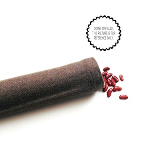 May include: A brown fabric tube with red kidney beans spilling out onto a white surface. The text in the image reads: COMES UNFILLED. THIS PICTURE IS FOR REFERENCE ONLY.