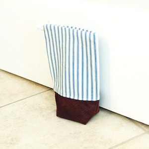 Fabric doorstop with zipper closure, unfilled door weight, blue ticking stripes