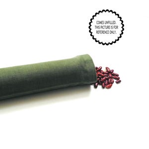 May include: A green cylindrical fabric item, partially filled with red kidney beans, lies on a white surface. The text in the image reads: "COMES UNFILLED. THIS PICTURE IS FOR REFERENCE ONLY."