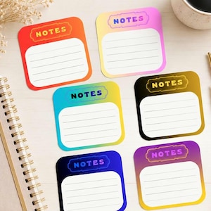 May include: A collection of six colorful sticky notes with the word "NOTES" at the top. Each note has a gradient background and lined space for writing. A spiral notebook, pens, and a coffee cup are also in the image.