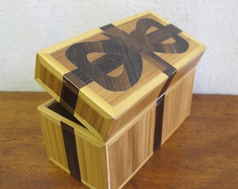 French straw marquetry box made by Rochas in the form of a gift box with bow, c. 1970