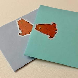 Bear stickers applied to colorful envelopes