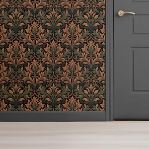 May include: Wallpaper with a repeating pattern of stylized leaves in shades of brown, green, and black. The wallpaper is on a wall next to a gray door with a gold-colored handle. The baseboard is dark gray.