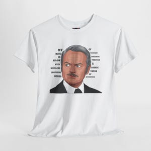 May include: White t-shirt featuring a portrait of a man with a mustache and the text "MY MIND IS AGLOW WITH WHIRLING TRANSIENT NODES OF THOUGHT CAREENING THROUGH A COSMIC VAPOR OF INVENTION".