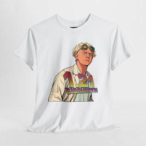 May include: White t-shirt featuring a cartoon illustration of a man with goggles, wearing a lab coat. The graphic includes the text "1.21 Gigawatts" in a colorful, retro font. The design is inspired by a science fiction movie.