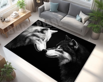 May include: Black and white area rug featuring two wolves in a close embrace. One wolf is white, the other is black, with detailed fur textures and piercing blue eyes. The rug is rectangular and placed on a light-colored floor.