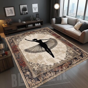 May include: A rectangular area rug with a ballerina silhouette in black. The rug has a beige center with a floral border in shades of red, blue, and beige. The ballerina is in mid-air with arms outstretched.
