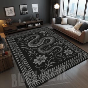May include: A black rectangular rug with a grayscale snake design. The snake is surrounded by floral and foliate patterns, within an ornate border. The rug is in a living room with a sofa and wooden flooring. The rug's dimensions are in centimeters.