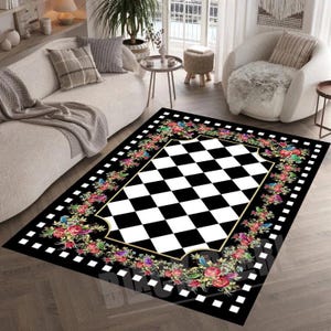 May include: Black and white checkered rug with a floral border. The flowers are pink, red, yellow, and green. The rug has a gold trim.