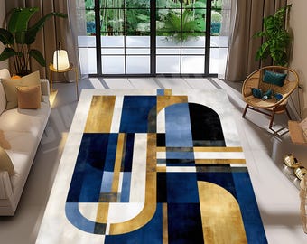 May include: A modern area rug with an abstract geometric design. The rug features a combination of navy blue, gold, black, and light blue shapes on a neutral background. The design includes rectangles, arches, and curved lines, creating a contemporary look.