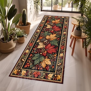 May include: A rectangular runner rug featuring a dark background with a vibrant pattern of autumn maple leaves in shades of red, orange, and yellow, interspersed with pinecones and small berries, enclosed by a decorative border with a geometric trim.