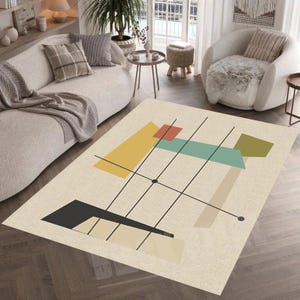 Op de afbeelding: Abstract geometrisch tapijt met een beige achtergrond en zwarte lijnen. Het tapijt heeft geometrische vormen in geel, groen, blauw en rood.