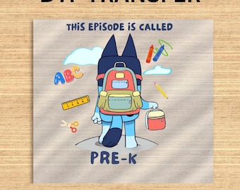 May include: DTF TRANSFER graphic featuring a cartoon character with a backpack, holding a lunchbox, and surrounded by school-themed illustrations. The text "THIS EPISODE IS CALLED" and "PRE-K" are visible. Includes ABCs, crayons, a ruler, scissors, and a pencil.