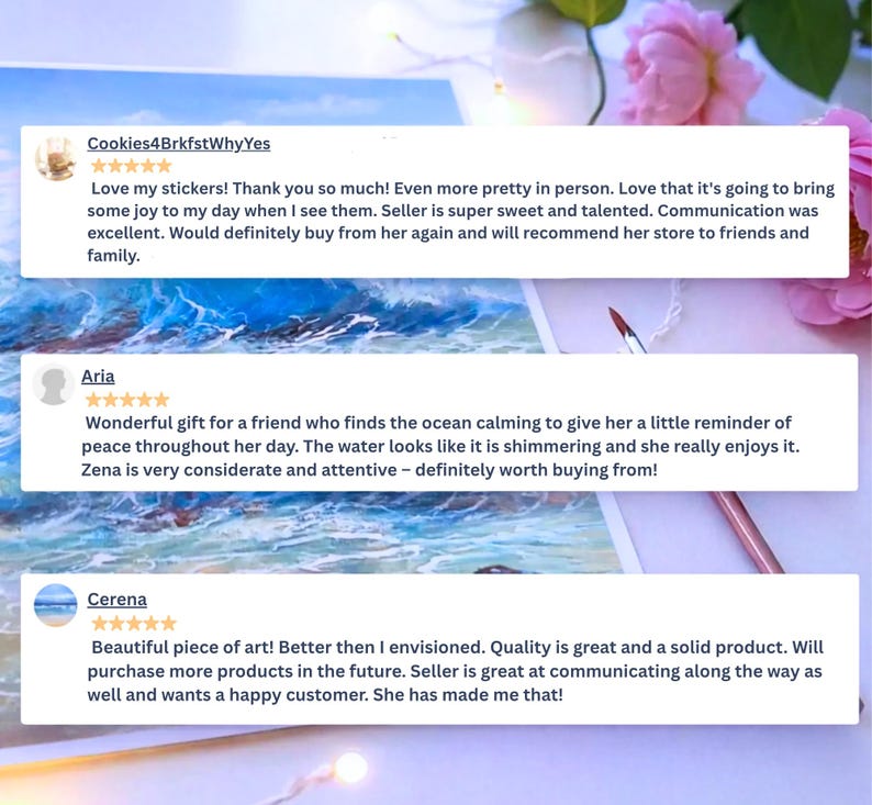 May include: A digital display of three customer reviews for an art shop, each featuring a five-star rating. The reviews are overlaid on a painting of blue ocean waves crashing against a rocky shore, accompanied by a thin paintbrush and pink flowers.
