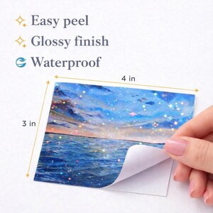 May include: A rectangular sticker measuring 4 inches by 3 inches, featuring a holographic sunset over the ocean. The sticker has an easy peel, glossy finish, and is waterproof. The design shows blue water and a cloudy sky with sparkling stars.
