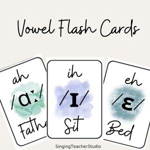 May include: Three rectangular white flash cards labeled Vowel Flash Cards. Each card features a phonetic symbol over a watercolor splash in green, purple, or blue, with corresponding text: ah/a:/Father, ih/I/Sit, and eh/ɛ/Bed. SingingTeacherStudio is at the bottom.