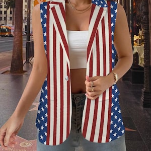 May include: Sleeveless blazer featuring a patriotic design with red and white stripes and blue panels with white stars. The blazer has a button closure and a tailored fit, perfect for a casual or semi-formal look. The garment is a bold statement piece.
