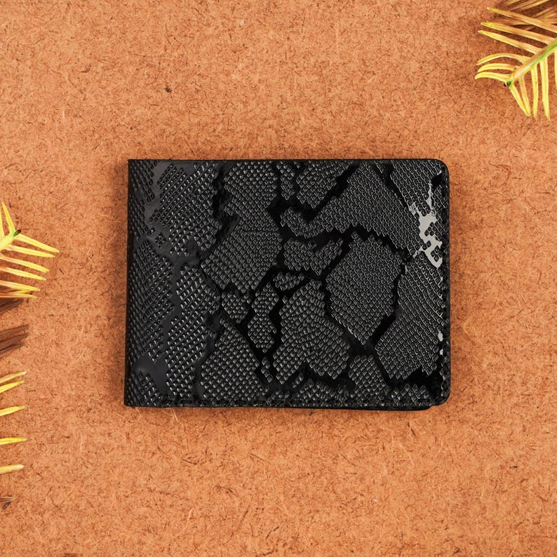 Handmade black python pattern leather wallet crafted from genuine leather with an exotic snakeskin-inspired texture. This slim bifold men’s wallet combines durability and elegance, featuring multiple card slots and a spacious bill compartment. Perfect anniversary gift, birthday gift, or stylish everyday accessory for men who appreciate unique handmade leather goods.