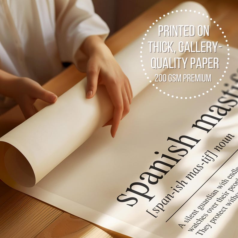 A person is holding a rolled-up poster or sheet of paper with the definition of "Spanish mas-tiff" written on it.