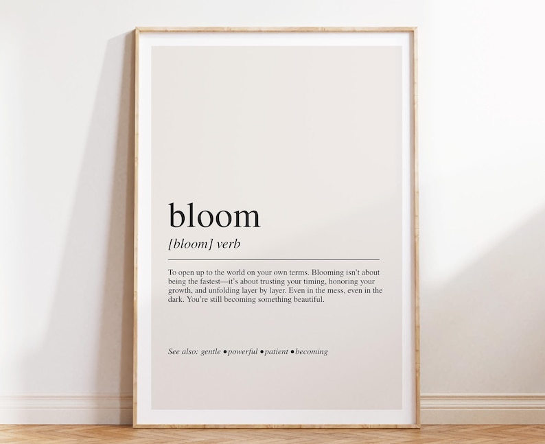 The image is a framed print with a definition of the word "bloom" and a message encouraging the viewer to embrace their own growth and beauty.