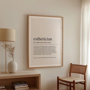a picture hanging on a wall next to a chair