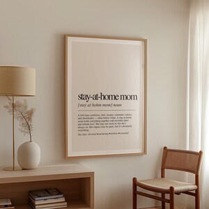 a picture hanging on a wall next to a chair