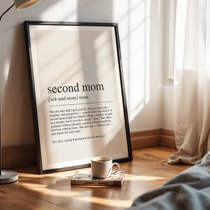 a picture frame sitting on a wooden floor next to a lamp