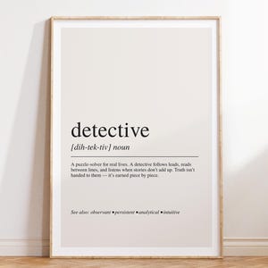 May include: A framed wall art print featuring a dictionary-style definition of the word detective. The text is printed in black on a light beige background, including the phonetic pronunciation, noun classification, and a descriptive paragraph.