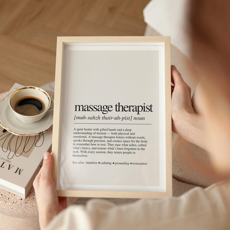 a person holding a framed book and a cup of coffee