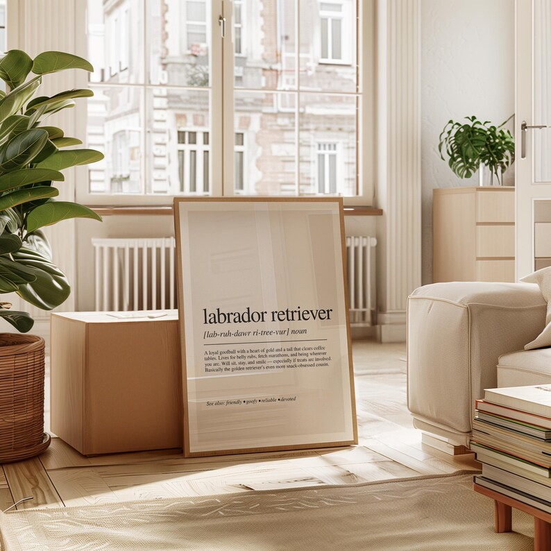 a living room with a plant and a poster on the floor